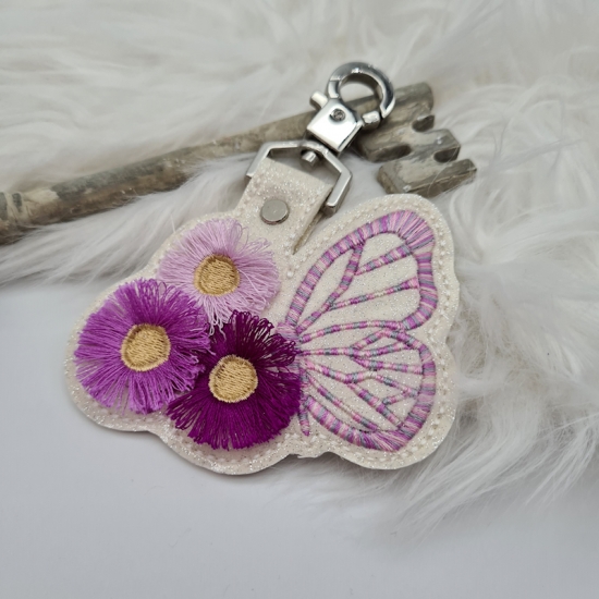 Taschenanhänger / Taschenbaumler Schmetterling mit Blumen weiß/rosa